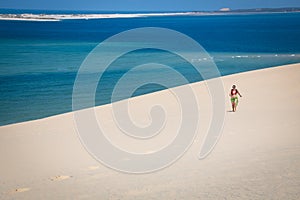 Girl walking on the white dunes on the Bazaruto Island