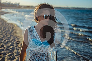 Girl walking on a windy beach