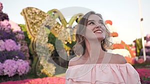 A girl walks through a beautiful fairytale park in Dubai.