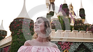 A girl walks through a beautiful fairytale park in Dubai.