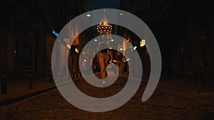 a girl walks down the street near the Galata tower