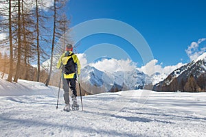 A girl walks with snowshoes in solitude