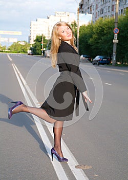 Girl walks on town lonesome road.