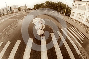 Girl walks on town lonesome road.