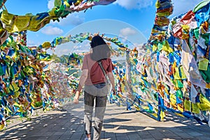 A girl walks under an arch with traditional Buddhist prayer flags in the Rinpoche Bagsha datsan in Ulan-Ude city of the