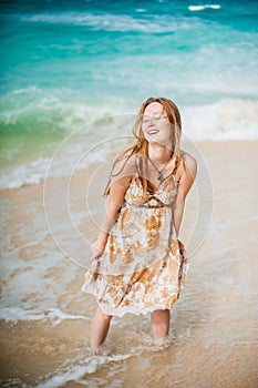 The girl walks on the water`s edge on the Boracay