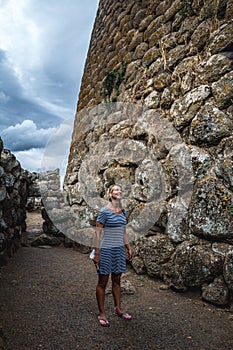 Girl wandering in ancient ruins in Sardinia, Italy.
