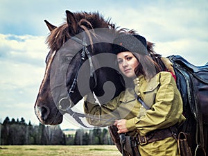 Girl warrior Cossack with a horse. Portrait. photo