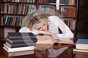 The girl was preparing for the exam reading book sleeping