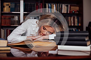 The girl was preparing for the exam reading book sleeping