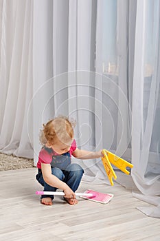 Girl washes the floor mop.