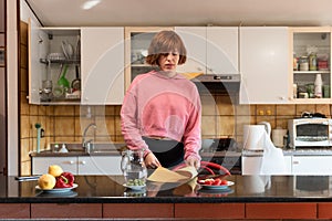 Girl washing dishes after lunch. Usual environment.