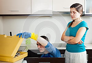 Girl watching as plumber working