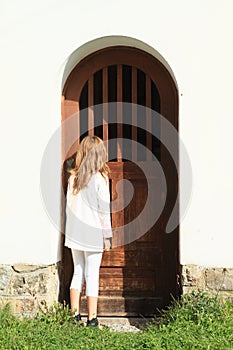 Girl watching behind door