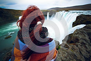 Girl watching at Godafoss waterfall, Iceland