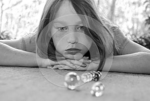 Girl watching marble game