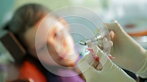 Girl Watching Orthodontist Correcting Braces For