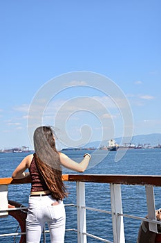 The girl watching the sea from the ferry