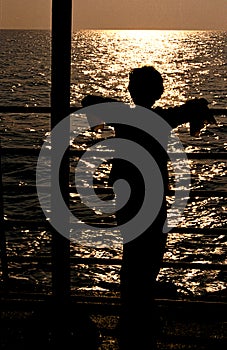 Girl Watching Sunset from Ship Deck