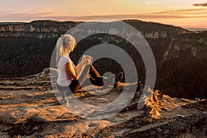 Girl is watching sunsets on cliff tops