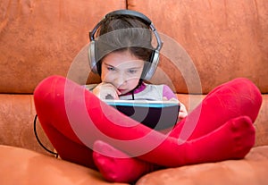 Girl watching tablet pc with headphones