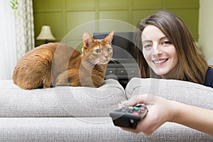 Girl watching tv with cat