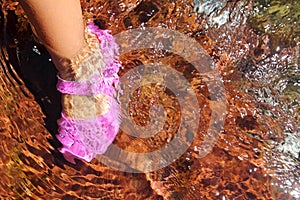 Girl water feet pink shoe in river stream