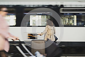 A girl is wating a train in a trian station at Geneva, Switzerland.