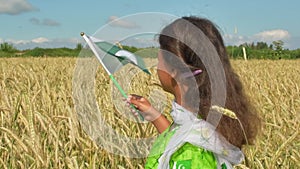 Girl waving flag of Pakistan outdoors . Happy independence day of Pakistan.