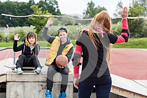 Girl waving goodbye at skatepark