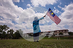 Girl waving the Malaysia Flag. Independence Day & Merdeka Concep