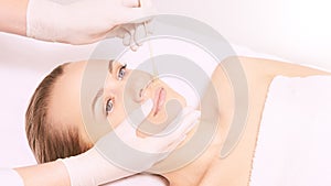 Girl wax lip at depilation center. Prfessional remove unwante hair on woman face