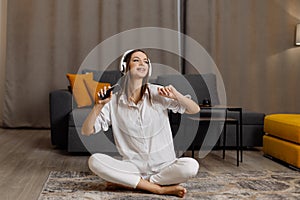 girl wear headphones using smartphone and watching online video course