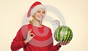 Girl wear santa hat drink watermelon vitamin cocktail straw. Woman enjoy vitamin drink. Rich vitamin ration concept