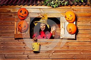 Girl wear witch Halloween costume with pumpkin