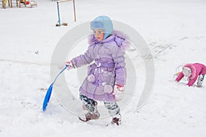 Girl wearily climbs icy hill