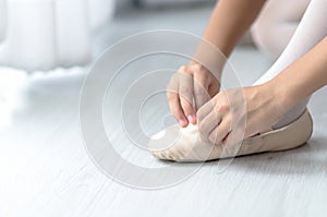 Girl wearing ballet shoes for preparing dance