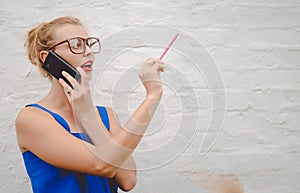 Girl wearing big glasses speaking phone and