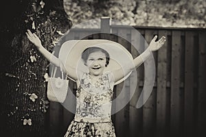 Girl Wearing a Big Sun Hat with Hands Up - Vintage