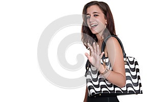 Girl wearing a black dress and a purse smiling and waving goodbye