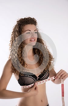 Girl wearing bra and holding tape measure