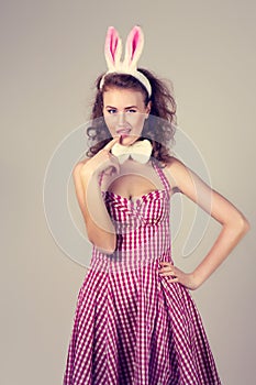 Girl wearing easter bunny costume with eggs in basket