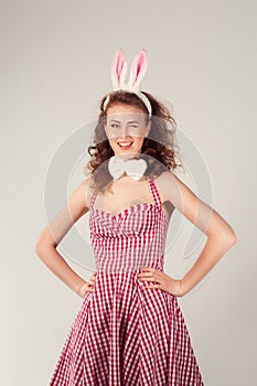 Girl wearing easter bunny costume with eggs in basket