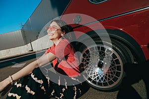 Girl wearing glasses enjoying of the warmness and sun while sitting