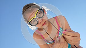 Girl wearing goggles with pebbles