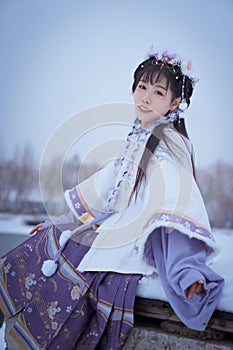 A girl wearing Hanfu outdoors in winter