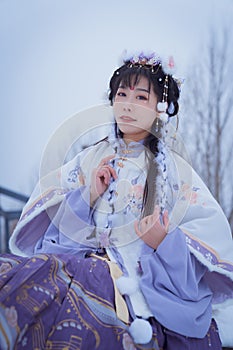 A girl wearing Hanfu outdoors in winter