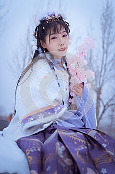 A girl wearing Hanfu outdoors in winter