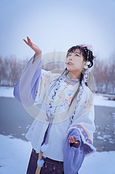 A girl wearing Hanfu outdoors in winter