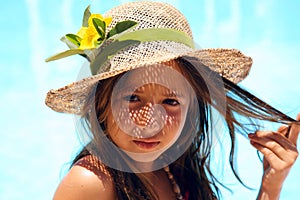 girl wearing a hat near pool